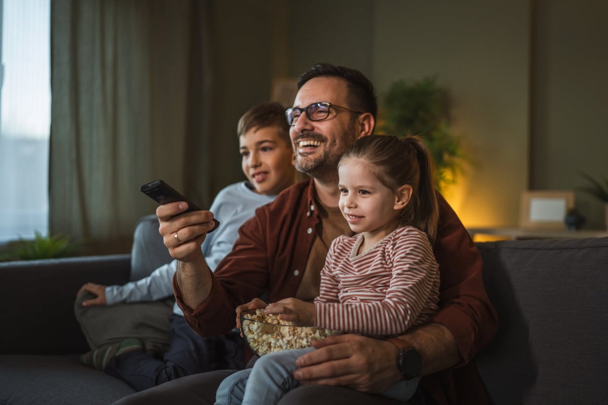 Family enjoying quality time together during a fun movie night