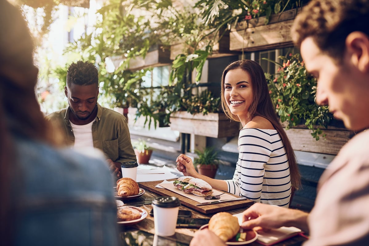 Happy woman enjoying lunch with friends at a local restaurant